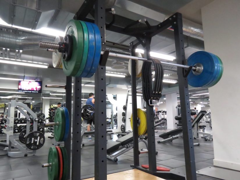 A bar in the squat rack with 145kg on